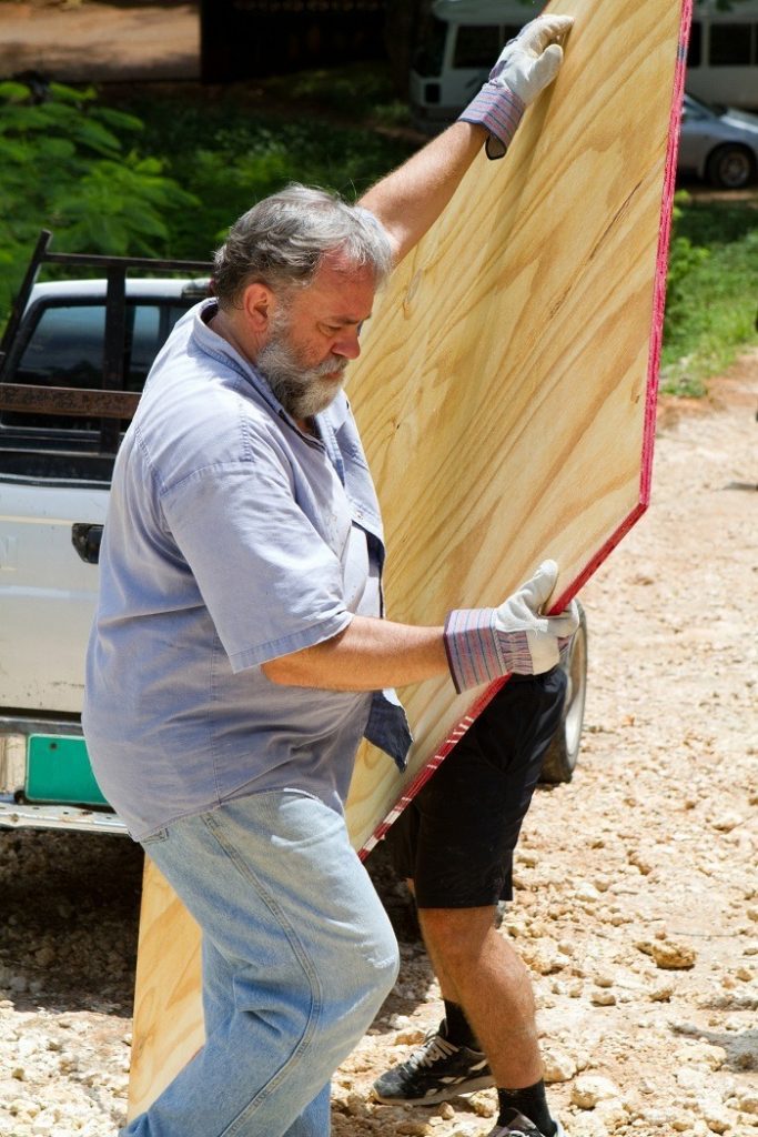 cabinet, grade, plywood, board, man, mature, carpenter, bearded, carrying, construction, gray, labor, laborer, lifting, lumber, male, manual, mature, pickup, truck, wood, worker, works