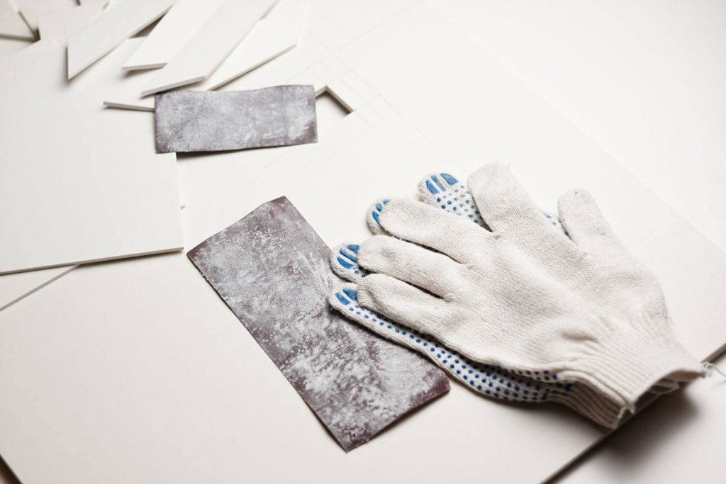 used sandpaper, gloves