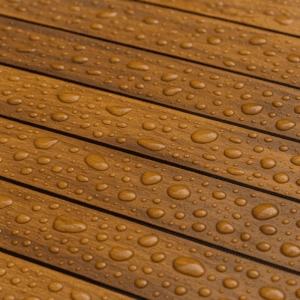 Teak deck with water droplets showing natural rot resistance