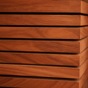 Stack of eucalyptus wood boards showing rich reddish-brown grain patterns