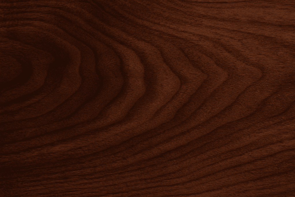 Close-up of walnut wood grain highlighting dark brown tones and natural patterns