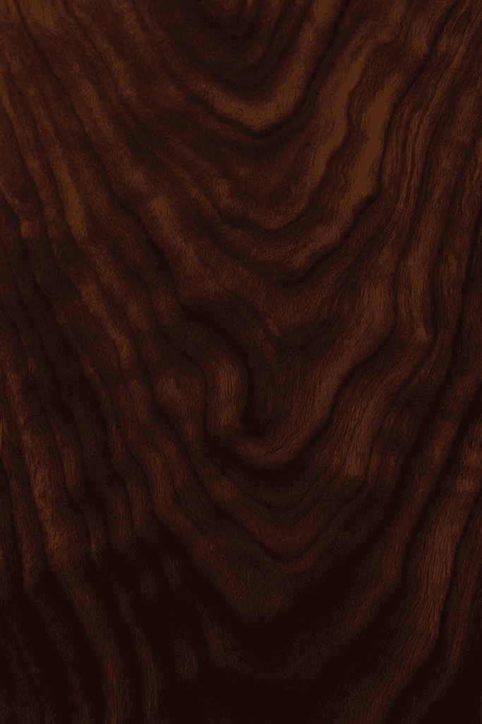 “Macro photo of walnut wood grain showing wavy, curly figure and deep brown tones.”