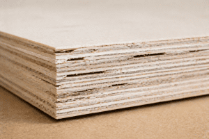Close-up of plywood edge showing multiple plies and visible internal voids indicating lower sheet quality