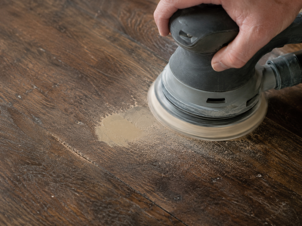 Sanding a cured Bondo Wood Filler patch flush with a wood floor