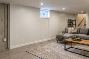 Basement Wall Panel Cost: Materials & Installation Finished basement with moisture-resistant wall panels installed over a concrete foundation wall.
