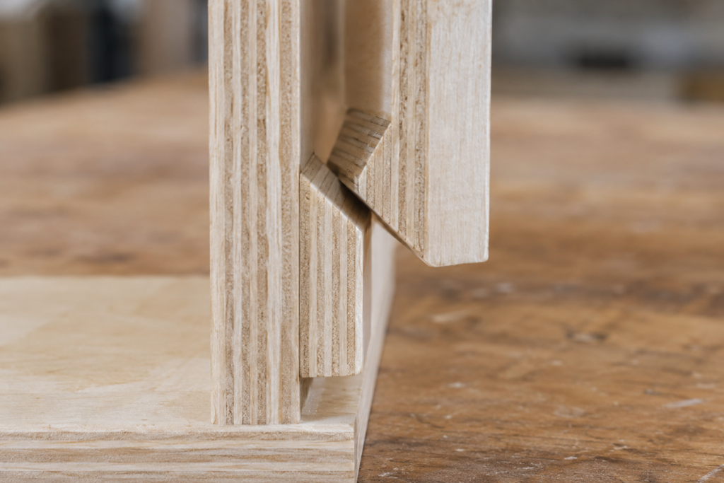 Close-up of two matching 45-degree plywood French cleats interlocking